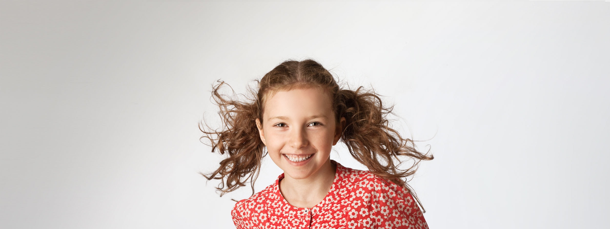 Girl with pigtails smiling